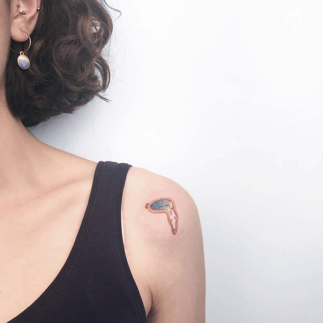 Salvador Dali color melting clock tattoo